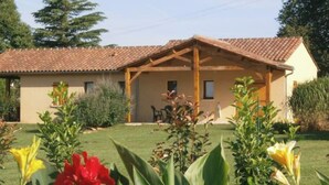 A building with a tiled roof and a covered patio area.