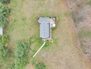 An aerial view of a building with a flat roof, a covered patio area with outdoor seating, and a visible pathway leading to the entrance. - Red Roost A-Frame - New Hot Tub (Rockbridge)