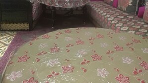 A room with a sofa set, a small round table, and a door with a blue frame. - House (Marrakech)