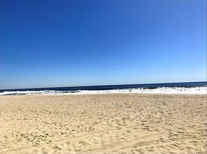 Enjoy a serene beach experience with a wide, sandy shoreline and calm waters.