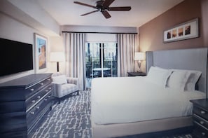 Relax in this inviting space with a large bed, flat-screen TV, and ceiling fan.