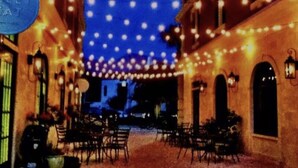 A narrow street with outdoor seating, string lights, and a sign that reads "LE VIEAT". - Coastal Comfort,Spacious and Bright Condo right on 30A (Seacrest)