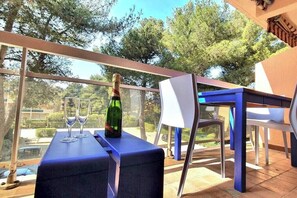 Relax and socialize on this balcony with a glass-enclosed view of the surrounding area.