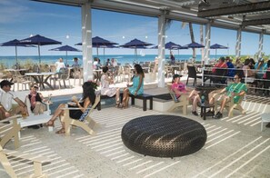 Relax in style with ocean views from our outdoor seating area, featuring and social spaces under shaded umbrellas.