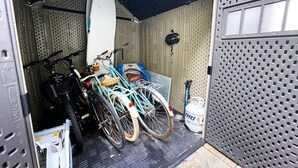 A garage with bicycles and a surfboard stored inside. - Recently Updated 2/2 With Hot Tub, 1 Mile to Beach (Lantana)