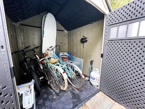 A garage with bicycles and a surfboard stored inside. - Recently Updated 2/2 With Hot Tub, 1 Mile to Beach (Lantana)