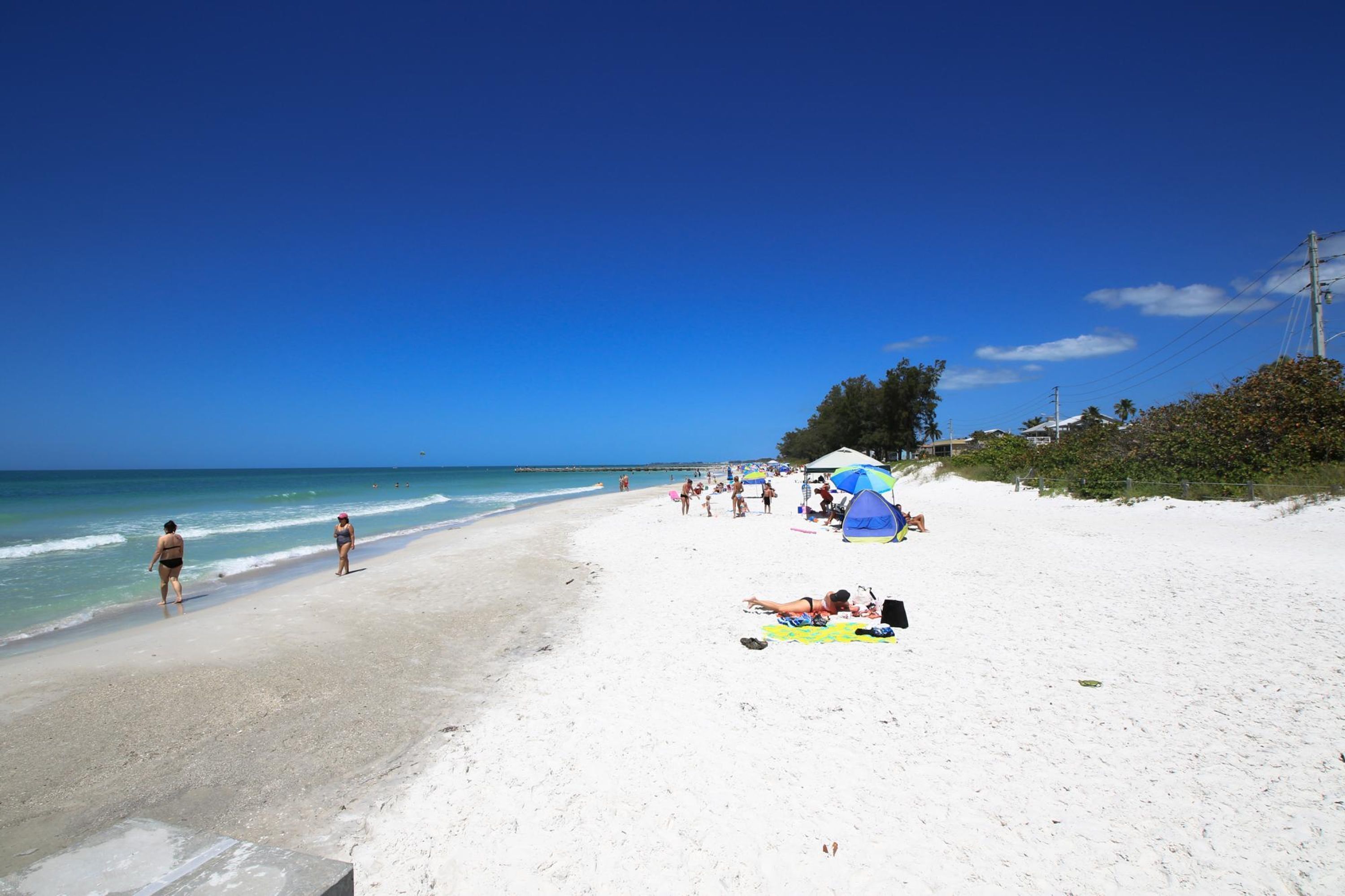 On the beach, white sand, beach towels, beach bar