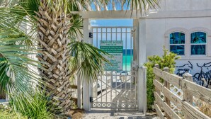 A gated entrance with a sign indicating private access for Emerald Waters Village, including Emerald Waters Beach and Seleta Townhomes. - Modern 2br/2ba, Pet friendly, steps to private beach access and restaurants! (Miramar Beach)
