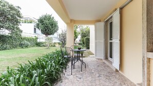 Un patio con piso de piedra, una mesa y sillas.