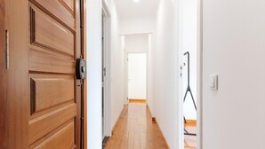 A hallway with wooden doors and white walls. - Belem Boutique V by Homing (Lisbon)