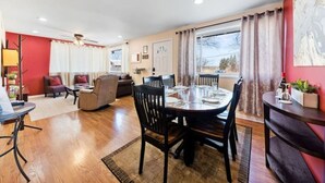 A spacious living area with a round dining table, multiple chairs, a sofa, and a TV. - PROMO 15% MONTHLY DISCOUNT!
Cozy House, Close to Benedictine & North Central (Lisle)