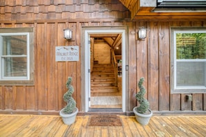 A wooden building with a sign reading "Walnut Ridge Est. 2021" and a staircase leading inside.