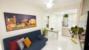 Family Apartment, Garden View | Living area | 40-inch TV with digital channels