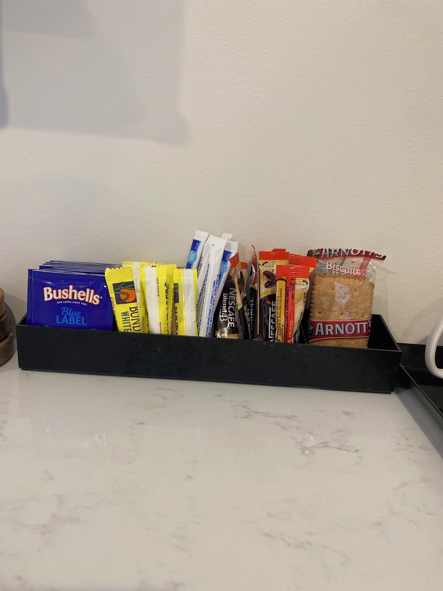 A snack tray with various packaged snacks including chips and biscuits.