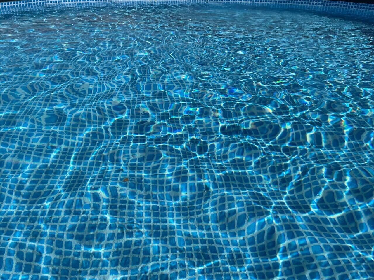 A clear view of a swimming pool with a tiled floor and no visible amenities or features.