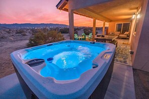 A hot tub with a view of the desert landscape at dusk. - Casa del Sol: 3BR Mountain View w/ Pool & Hot Tub (Joshua Tree)