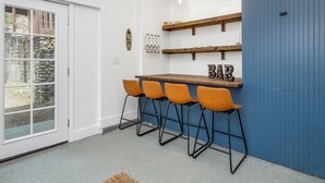 A bar area with four stools, a wooden counter, and a 'BAR' sign. - Bass Lake House|Boat Slip|BBQ| Fire Pit |3/2 (Bass Lake)
