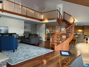 Relax in this inviting living area with a sofa, armchair, and patterned rug.