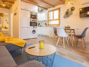 A modern apartment with a kitchen, dining area, and living room.
