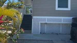 A single-story mobile home with a number '316' on the side, a small porch, and a vehicle parked in front. - Relaxing  Home in gated community (Cudjoe Key)