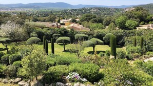 A lush garden with neatly trimmed hedges and a variety of trees, including tall cypress trees. - Golfvilla Riviera - luxury villa in the Golfe de Saint Tropez (Grimaud)