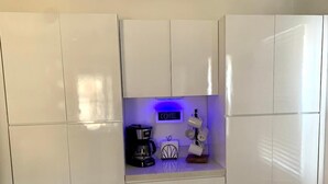 A kitchen area with a coffee station, including a coffee maker, cups, and a sign that says "COFFEE". - Wineries, Hiking, skiing  and fishing minutes from house (Saylorsburg)