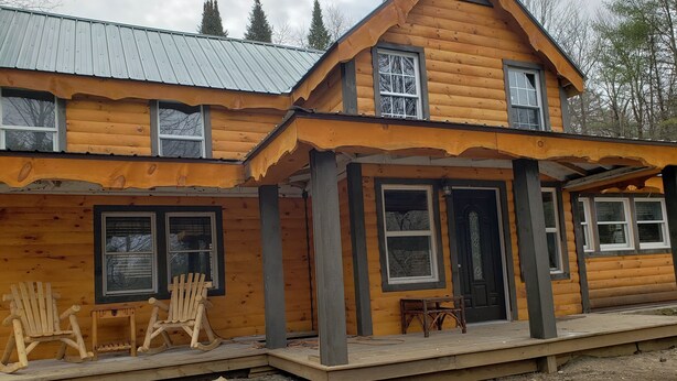 A log cabin with a porch, two windows, and a door. - 2 STORY ADIRONDACK LOG CABIN-SKI ! SKI! SKI! (Lake George)