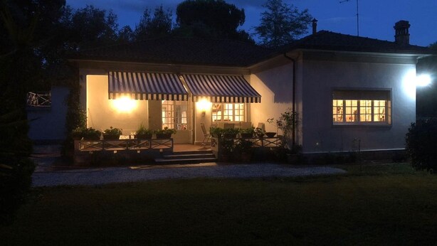 A two-story house with a covered patio, a visible front door, and a small garden area. - 3 Bedroom Villa in Massa (Massa)