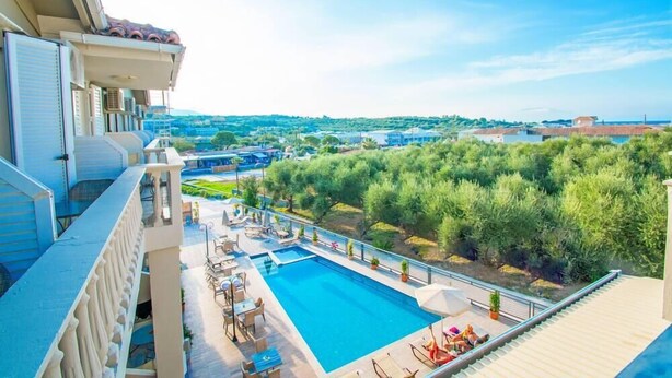 A rooftop pool area with lounge chairs and a view of the surrounding landscape. - The Senses Tsilivi Hotel (Zakynthos)