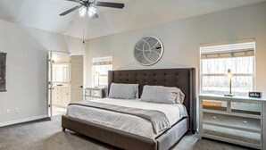 A bedroom with a large bed, a ceiling fan, a dresser, and a window with blinds. - Pet-Friendly Tulsa Escape w/ Private Hot Tub! (Tulsa)
