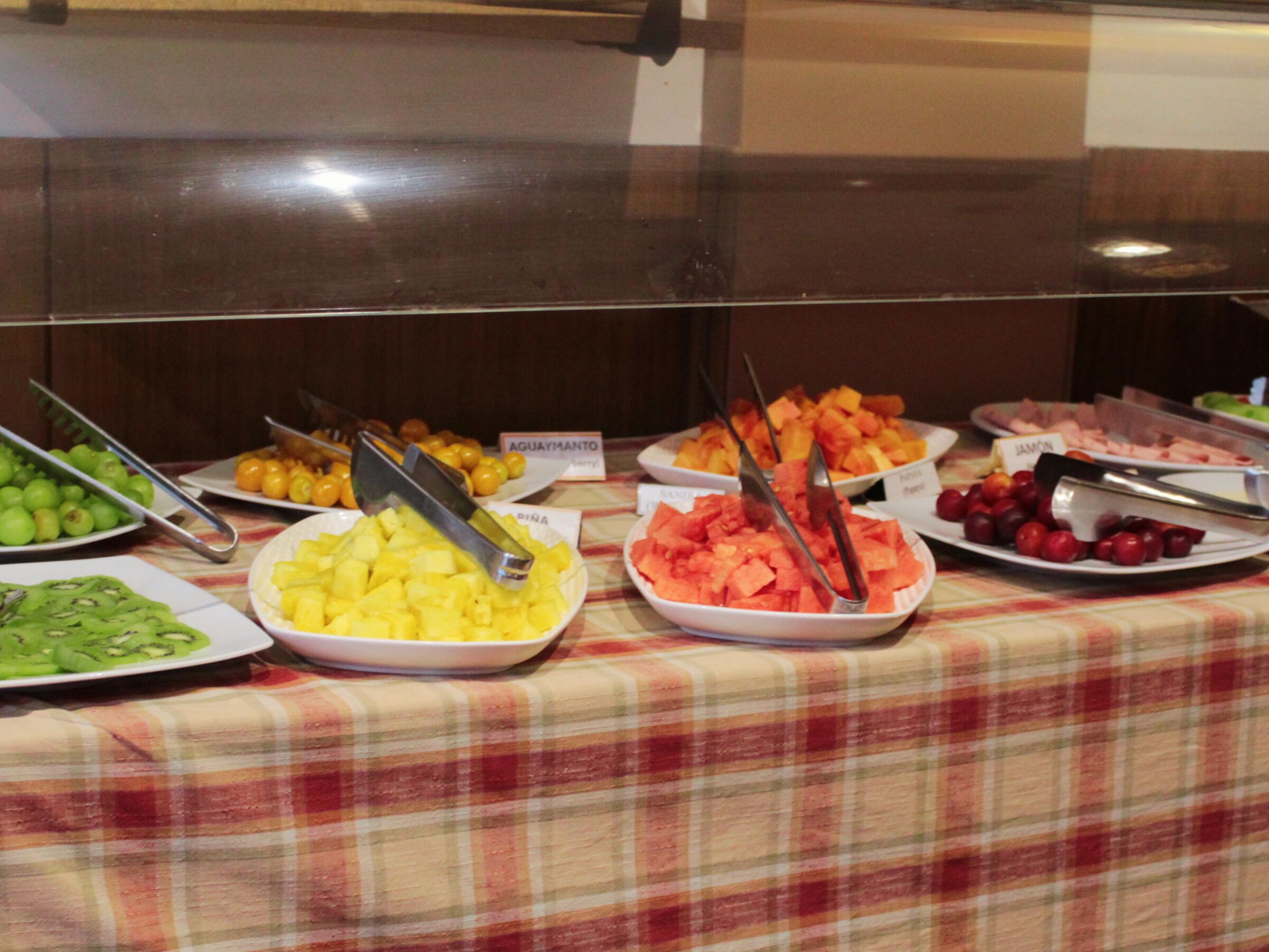 A buffet with various fruits and vegetables.