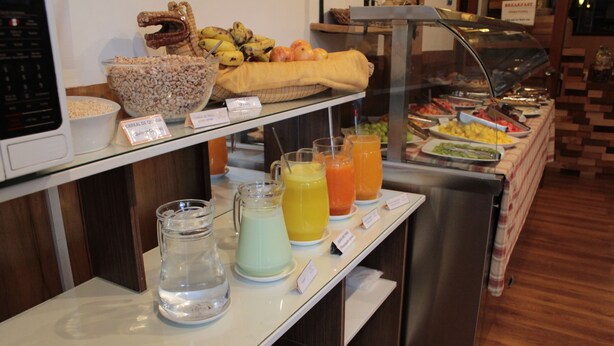 A breakfast buffet with various food items and beverages. - KAARO HOTEL SUITE (Puno)