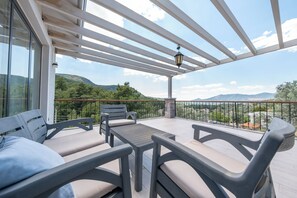 A covered outdoor seating area with a view of the landscape. - Olive Hills Villa Family-Friendly Luxury Villa with Private Pool in Fethiye (Fethiye)