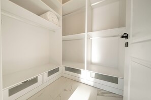 A white closet with open shelves and a door. - Olive Hills Villa Family-Friendly Luxury Villa with Private Pool in Fethiye (Fethiye)