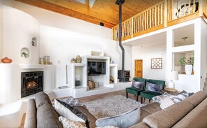 Cozy living area with a fireplace, TV, and comfortable seating.