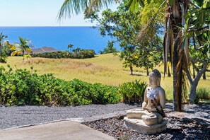 A statue in a garden with a view of the ocean. - *NEW LISTING Sunset Views, Pool and Spacious Modern Comfort Getaway!! (Waimea,)