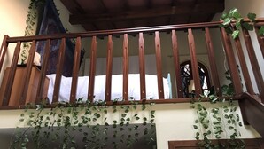 A wooden balcony with a white curtain, surrounded by climbing plants. - Loft Angela Charming Aptmnt in Pietrasanta Center (Pietrasanta)