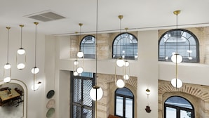 A room with arched windows, hanging pendant lights, and a visible fireplace. - Pera Rasso Hotel Boutique Hotel (Istanbul)