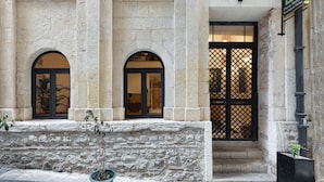 A historic building with arched windows, a stone facade, and a black gate. - Pera Rasso Hotel Boutique Hotel (Istanbul)