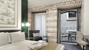 A hotel room with a large bed, a chair, a small table, and a balcony with a table and chairs. - Pera Rasso Hotel Boutique Hotel (Istanbul)