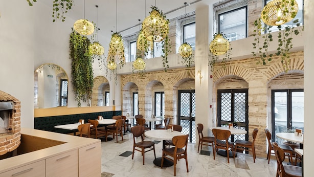 A restaurant with brick arches, hanging plants, and wooden chairs. - Pera Rasso Hotel Boutique Hotel (Istanbul)