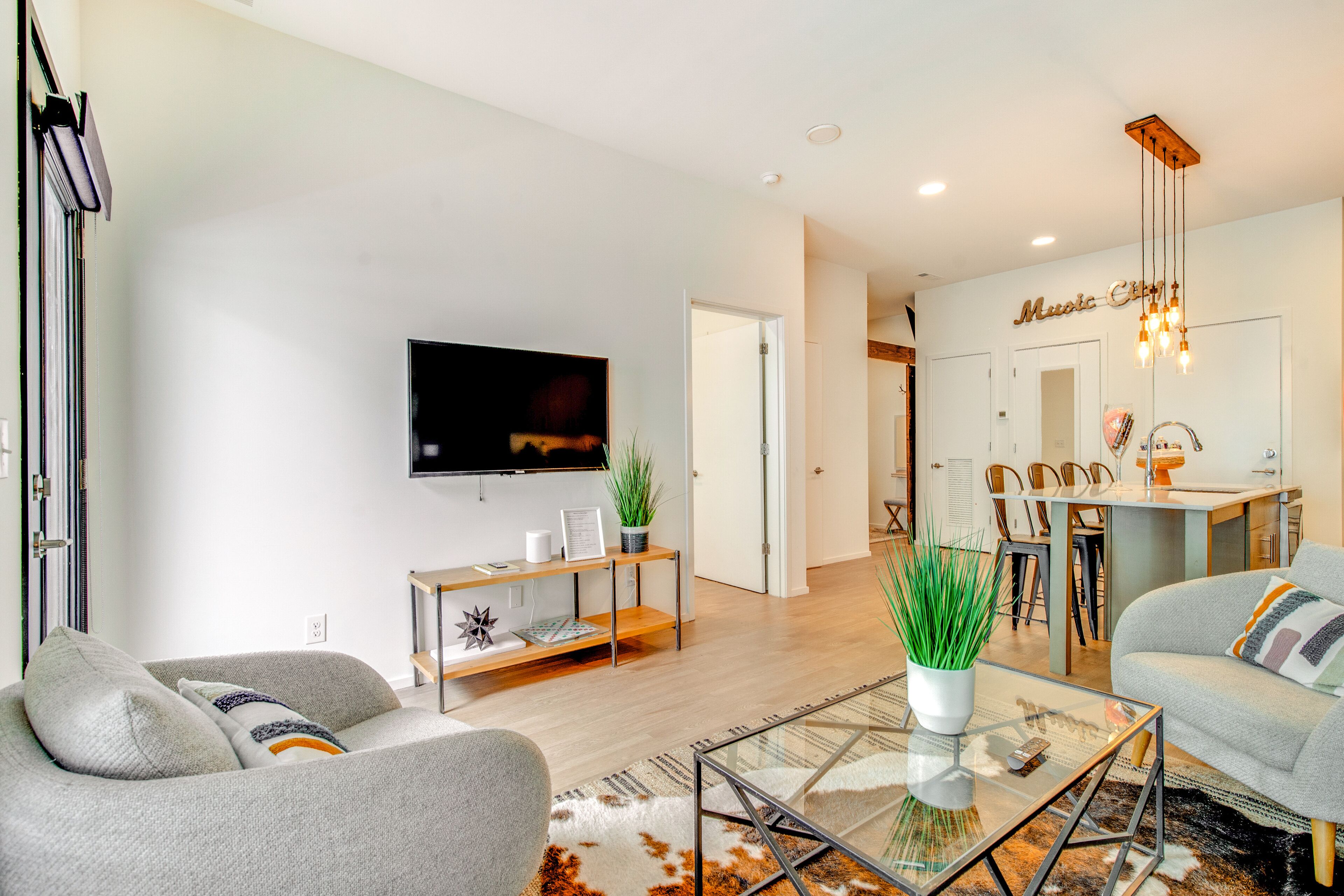 Modern condo near attractions with outdoor pool, balcony, central AC, and WiFi