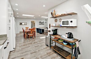 Enjoy cooking in this well-equipped kitchen with a dining table, oven, and microwave.