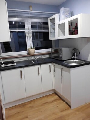 Fridge, microwave, oven, stovetop - Self Catering Studio Flat with Separate Kitchen (JUNIPER GREEN, EDINBURGH)