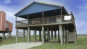 A wooden structure with a balcony, a covered area, and a small attached shed. - 2nd Row Beach House just steps to the sand!  EV  charger! (Surfside Beach)