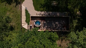 An aerial view of a house with a swimming pool, a wooden deck, and a staircase leading to the pool area. - ICI - Tiny house 40 m2 for 4 people (Arette)