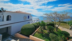 A coastal building with a sign reading "WWW STUDIO'S PAVLOS". - Pavlis Studios Ormos (Samos)