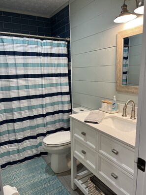 Bathtub, hair dryer, towels, soap