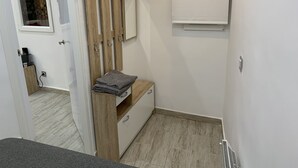 A modern bathroom with a wooden vanity, a towel rack, and a mirror. - Charming apartment in the old center of Madrid (Madrid)