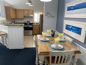 Enjoy meals in the well-equipped kitchen and dining area with a wooden table and sink.